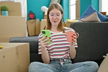 Woman accessing the U-Pack dashboard on her cell phone to manage her move.