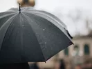 Black umbrella used to protect items when moving in the rain.